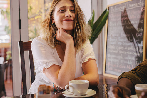 Woman sitting at cafe with her friend