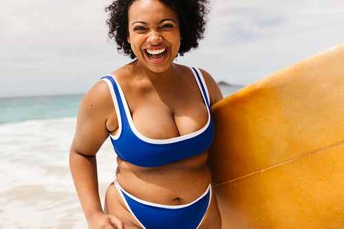 Adventurous female surfer having fun at the beach in summer