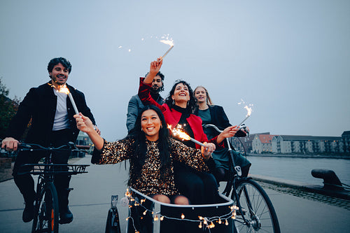 Group of friends enjoying sparklers during an evening bike ride