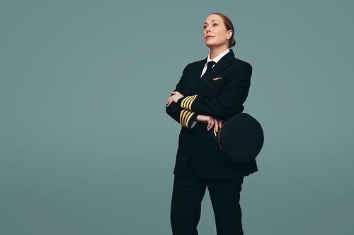 Female pilot standing in a studio