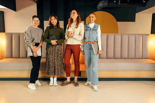 Female entrepreneurs standing together in an office lobby
