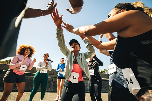 Group celebrating success after a running event outdoors