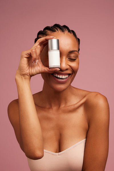 Woman with beautiful skin showing a beauty product