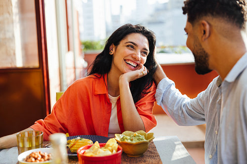 Smiling couple enjoying a romantic meal together at home