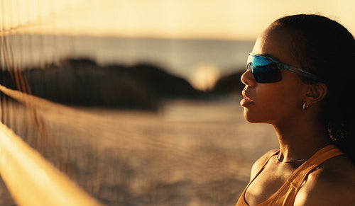 Championship beach volleyball: Pro tour athlete in action at coastal sunset