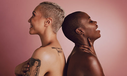 Two diverse women models standing back to back