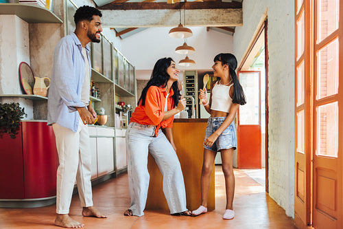Latin American family enjoying time together in a modern kitchen setting