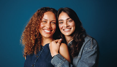 Female women friends stand together in a studio portrait with diversity and confidence