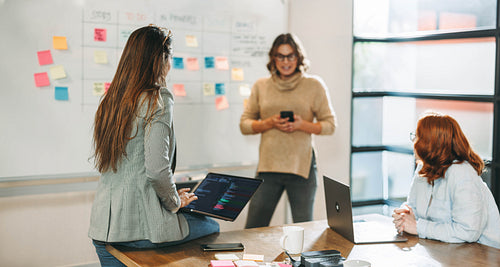 Creative business meeting: Women brainstorming with a scrum master at a tech startup