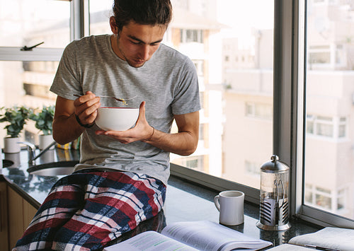 Student eating food while studying
