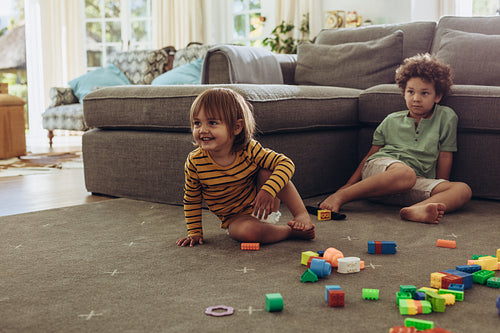Kids playing at home sitting on floor