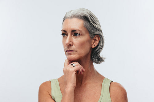 Fit mature woman looks pensive wearing a smart ring