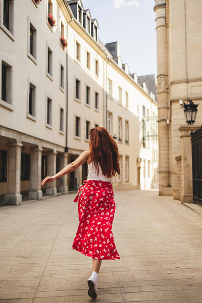 Female tourist running through the streets in a city