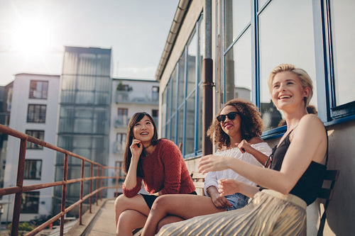 Smiling women relaxing outdoors in terrace