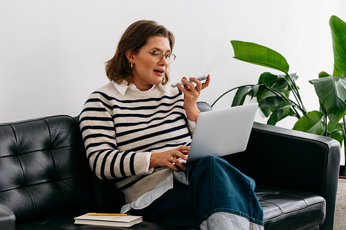 Her home office routine shows the woman on a couch during a smartphone call