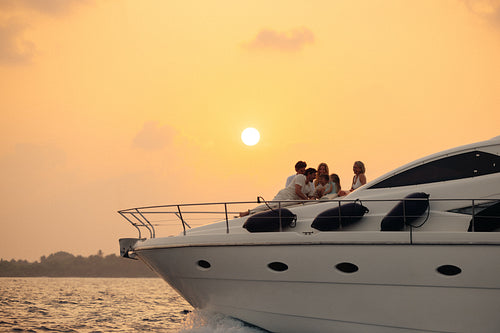 Luxurious yacht sunset cruise: Wealthy family enjoying the experience