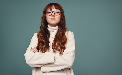 Woman wearing purple tinted eye glasses in a studio