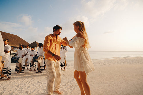 Young couple dancing on a beach at a resort in the Maldives