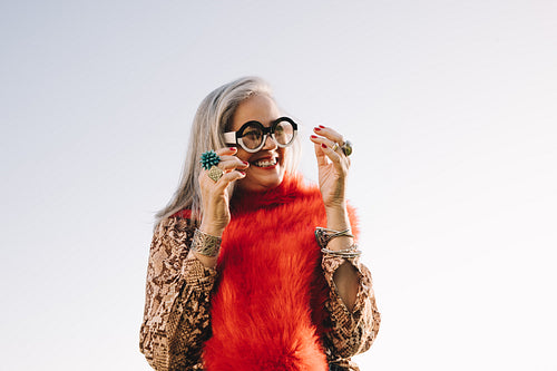 Happy mature woman smiling cheerfully outdoors