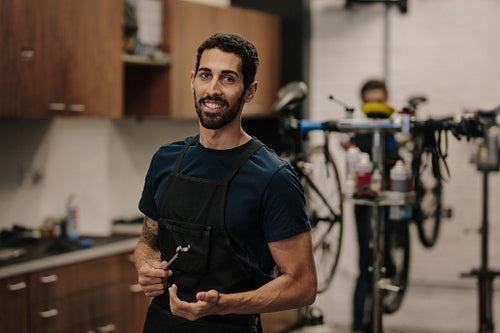 Workers repairing bicycles in workshop