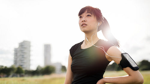 Fitness woman standing in urban park