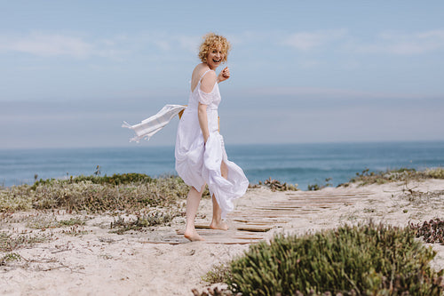 Happy woman running on the beach