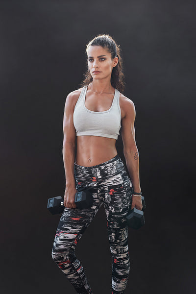 Muscular sportswoman with dumbbells