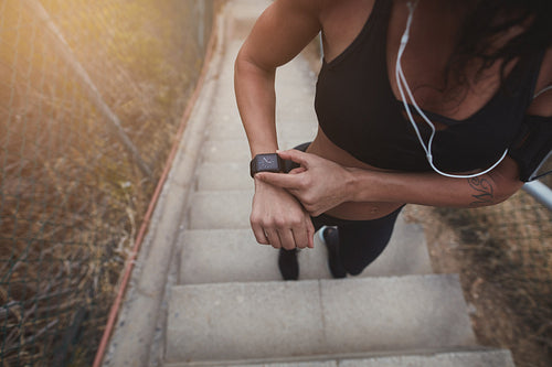 Fitness woman checking the time on a smartwatch