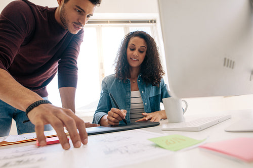 Business colleagues sitting together and discussing work in office