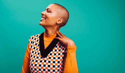 Confident short-haired woman smiling in a studio