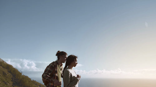 Couple in love on mountain peak and looking at view