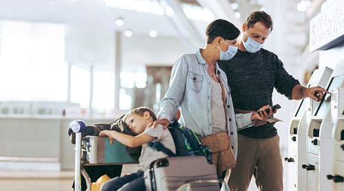 Family doing self service check-in at airport