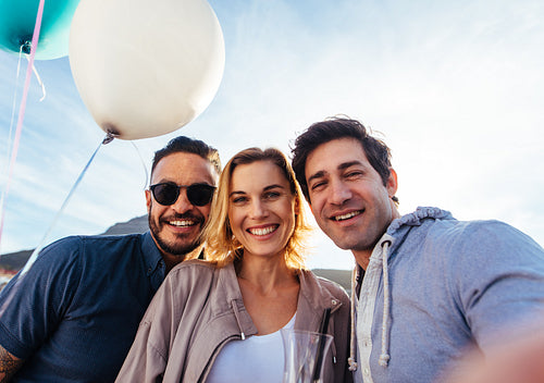 Friends taking self portrait during a party