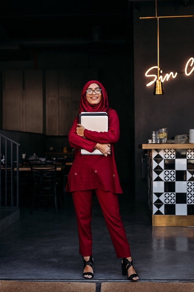 Muslim business woman standing at restaurant door