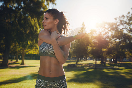 Young female athlete stretching before fitness training
