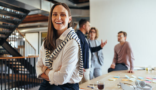 Business woman in her 30's looking at the camera in a boardroom