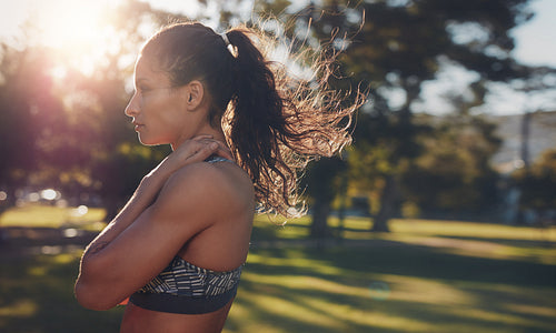 Fit young woman standing at a park