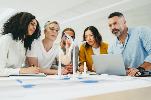 Multicultural designers working on a wind turbine project