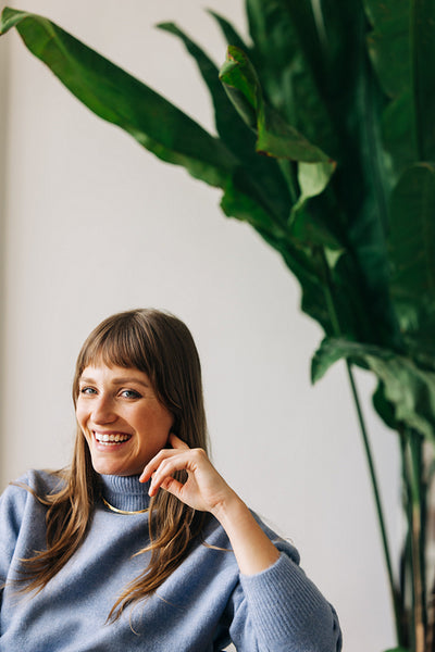 Young female entrepreneur smiling cheerfully in an office