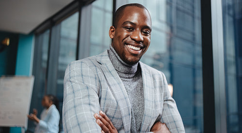 Businessman standing in a boardroom with a happy smile
