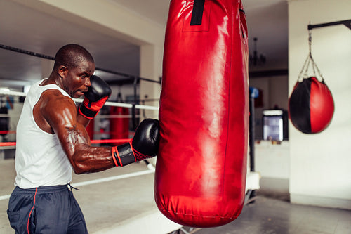 Muscular African boxer practicing his punches