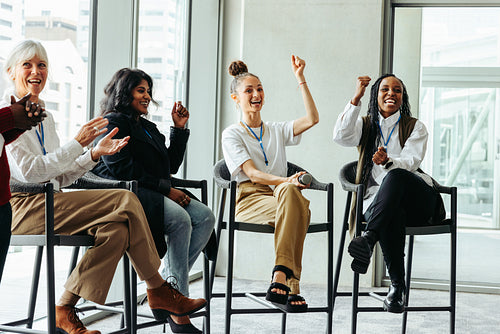 Diverse group of happy people engaging in a business panel presentation