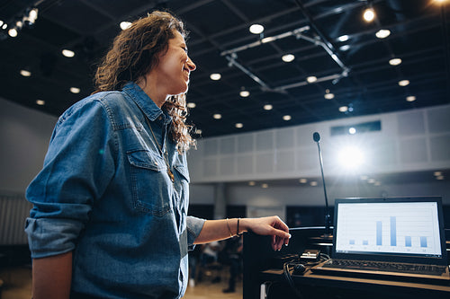Female professional addressing public in a convention