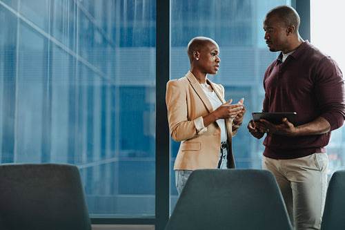 Successful business colleagues collaborating with a diverse team in a modern office