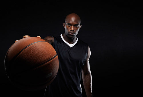Professional basketball player against black background