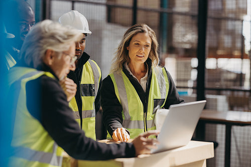 Logistics staff watching a slideshow presentation during a meeting