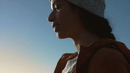 Woman hiker standing outdoors and looking around