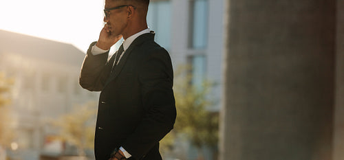 Man talking over mobile phone outdoors
