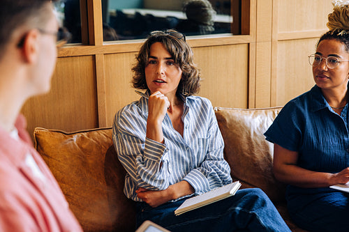 Young professionals engaged in discussion during a casual meeting