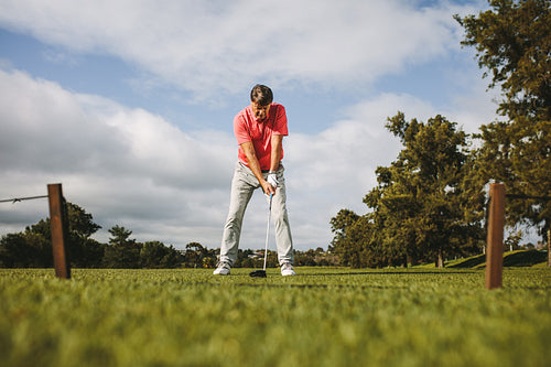 Senior golf player about to take the shot